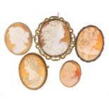 Five Victorian cameo brooches with gilt metal and silver mounts, the largest 5.5cm high :For Further