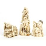 Two Japanese carved ivory Okimonos and a Netsuke of two figures with a demon, the largest 7cm