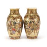 Pair of Japanese Satsuma pottery vases, hand painted and gilded with figures, each 18.5cm high :