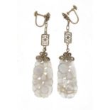 Pair of Chinese white metal mounted agate earrings carved with flowers, 7.5cm in length, 9.8g :For