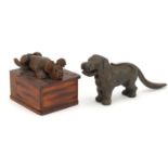 Novelty Black Forest carved box and a pair of dog design cast iron nutcrackers, the largest 23cm