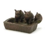 Japanese patinated bronze of three piglets in a trough, impressed character marks to the