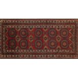 Rectangular Oranda rug, having an all over geometric design onto a red ground, 175cm x 90cm : For