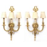 Pair of Louis XVI style three branch brass wall sconces with shades, 67cm high :For Further