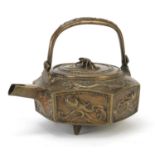 Chinese three footed bronze teapot cast with panels of fish, six figure character marks to the base,