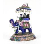 Tibetan silver coloured metal and enamel model of figures on elephants back, set with pink