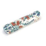 Islamic Iznik pottery pen case, hand painted with flowers, 32cm in length :For Further Condition