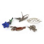 Four silver brooches and one other including two marcasite birds and one silver and enamel long boat