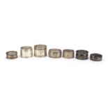 Seven silver and white metal napkin rings, various hallmarks, 152.4g :For Further Condition