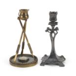 Art Nouveau pewter candlestick and one other in the form of a cauldron being supported by three