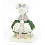 Austrian Art Deco pottery figure of a girl holding a parasol on a bench by Goldscheider, signed