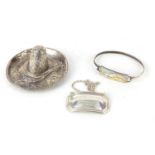Silver items comprising a sterling sombrero dish, decanter label and mother of pearl bangle, various