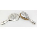 Victorian silver hand mirror and brush by W J Myatt & Co, each embossed with continental gentleman