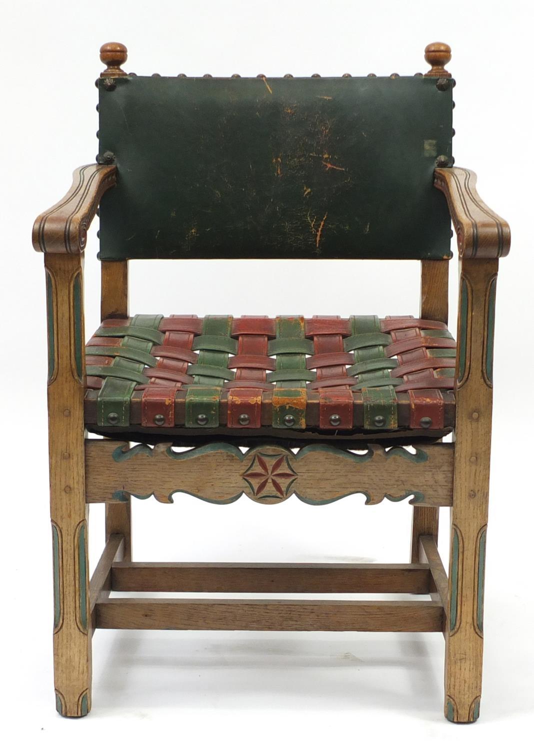 Carved oak open arm chair with red and green leather strap seat, 85cm high :For Further Condition - Image 2 of 4