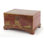 Chinese red lacquered casket gilded in the chinoiserie manner with figures before a palace and