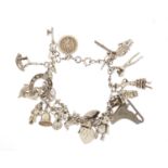 Silver charm bracelet with a selection of mostly silver charms including Spanish dancers, penny