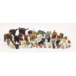 Collection of model elephants including porcelain, wood, pottery and metal examples, the largest