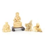 Three Japanese carved ivory Netsukes and a carving of Buddha on wood stand, the largest 7cm high :
