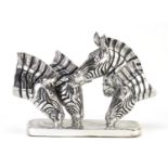 Silvered sculpture of four zebra heads, 45cm wide :For Further Condition Reports Please Visit Our