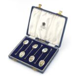 Set of six silver and enamel coffee bean spoons by Henry Clifford Davis, housed in a fitted velvet