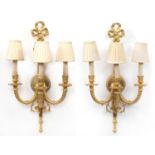 Pair of Louis XVI style three branch brass wall sconces with shades, 67cm high :For Further