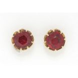 Pair of Indian unmarked gold red stone solitaire earrings, 5mm in diameter, 2.3g :For Further