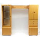 Beech illuminated wall unit by John Coyle, fitted with a series of cupboard doors, drawers and glass