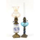 Two oil lamps with ornate metal mounts, one converted for electric use :For Further Condition