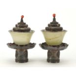 Pair of Chinese green jade tea bowls with silver coloured metal stands and lids, each finely