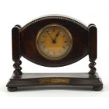 Oak cased mantel clock with barleytwist supports and military interest inscription, 27cm wide :For