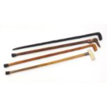 Four walking sticks including a Malacca example with ivory handle and silver collar, and an