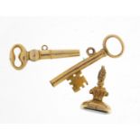 Two unmarked gold watch key pendants and a Victorian unmarked gold fob, the largest 2.7cm in length,
