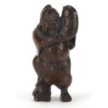 Japanese carved boxwood Netsuke of a fisherman holding a fish, character marks to the reverse, 5.5cm
