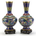 Pair of Chinese Cloisonne vases on carved hardwood stands, each enamelled with butterflies amongst