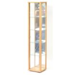 Contemporary light wood illuminated display cabinet, fitted with four glass shelves, 176cm H x