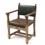 Carved oak open arm chair with red and green leather strap seat, 85cm high :For Further Condition