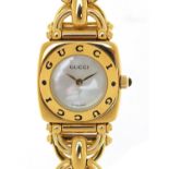 Ladies gold plated Gucci wristwatch with mother of pearl dial, with box and warranty booklet, the