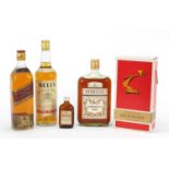 Four bottles of alcohol including Johnnie Walker Red Label whiskey, Hennessy Bras Armé cognac and