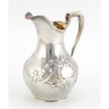 Victorian silver milk jug by William Ker Reid, embossed with foliage and gilt interior, London 1849,