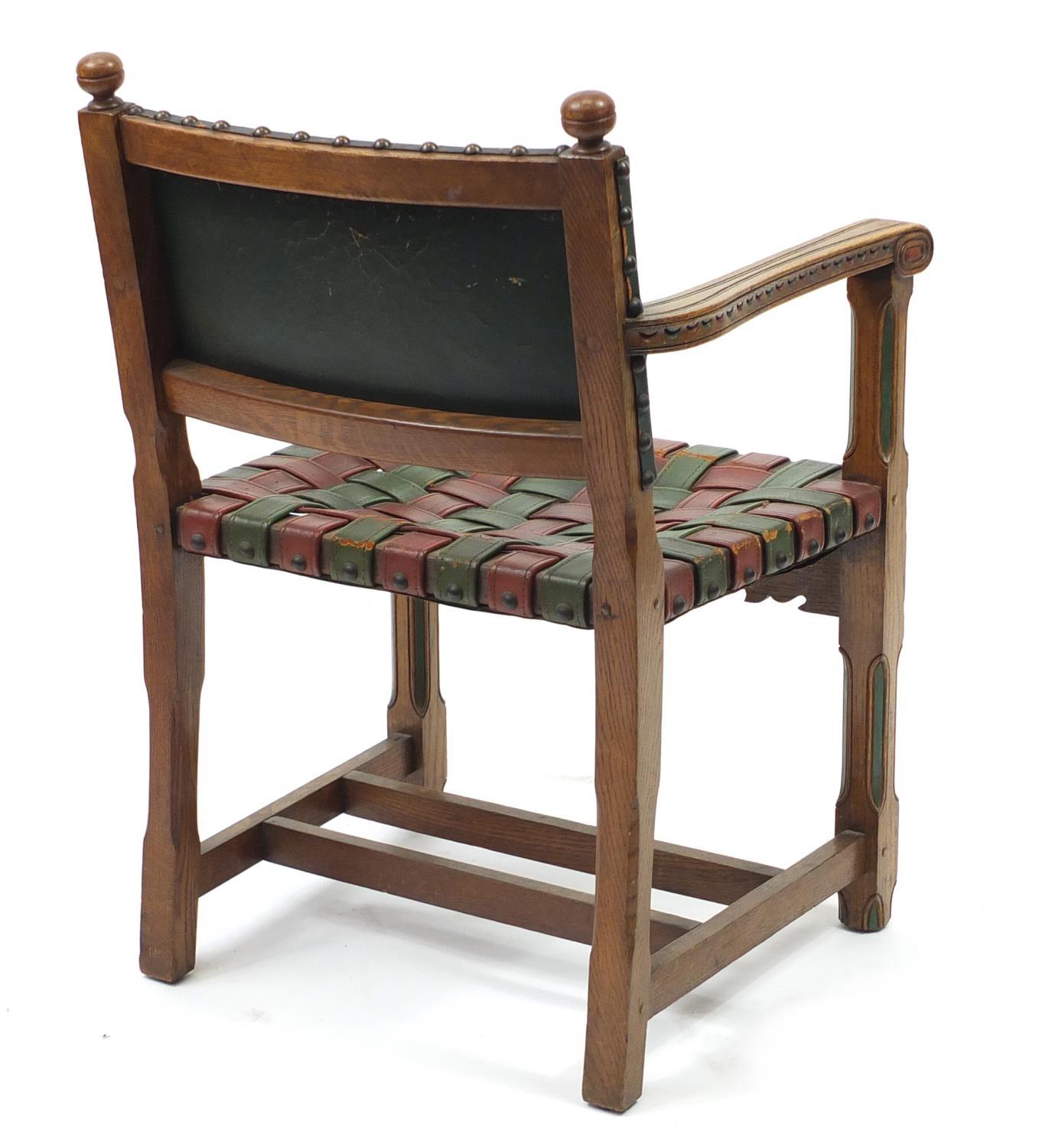 Carved oak open arm chair with red and green leather strap seat, 85cm high :For Further Condition - Image 4 of 4