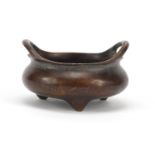 Chinese patinated bronze tripod censer with twin handles, character marks to the base, 8cm wide :For