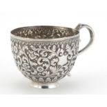 Indian unmarked silver cup, profusely embossed with flowers and foliage, (tests as silver) 5.5cm