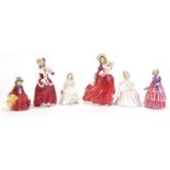 Five Royal Doulton figurines including Autumn Breezes HN1934 and Christmas Morn HN1992, the
