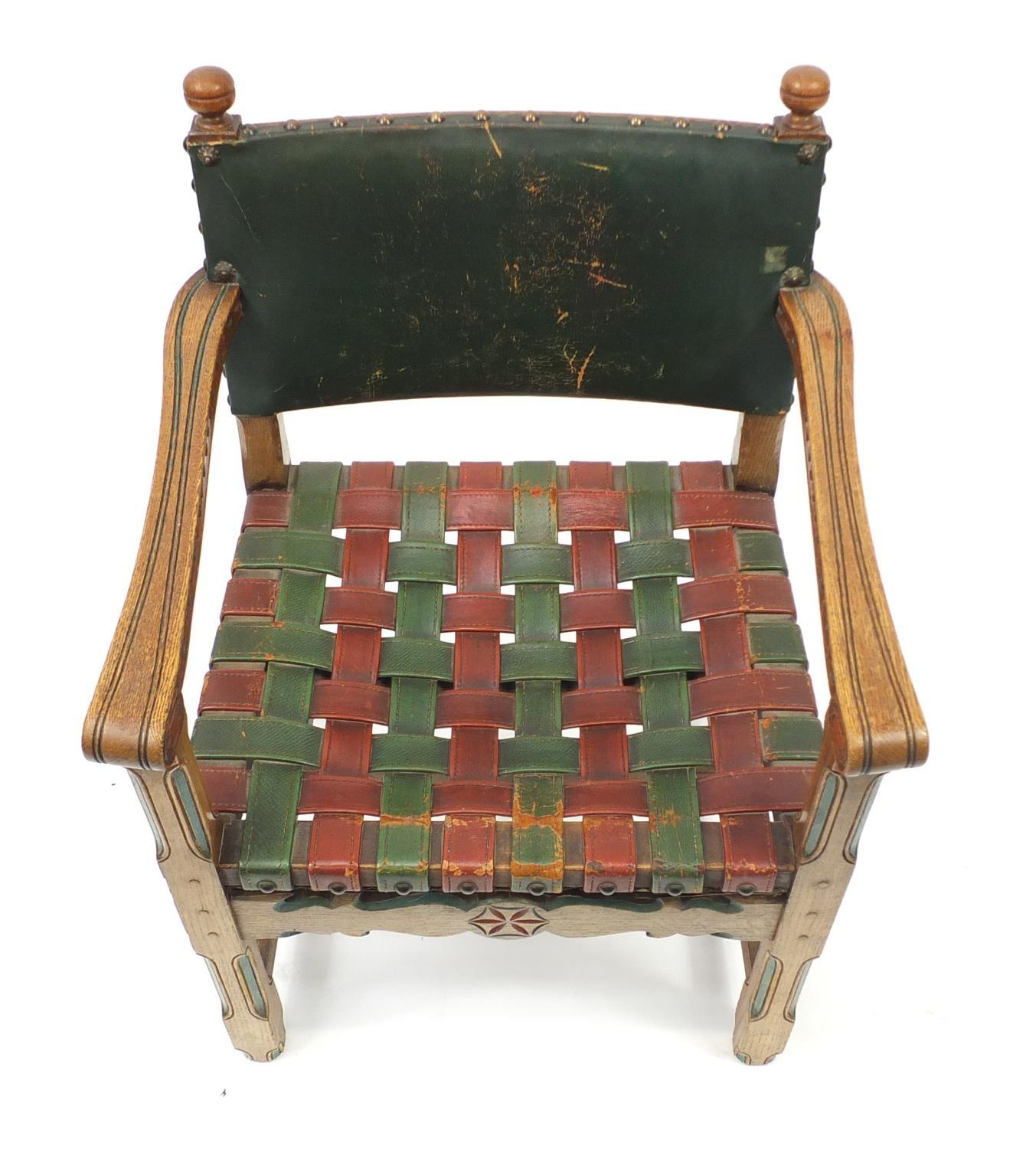 Carved oak open arm chair with red and green leather strap seat, 85cm high :For Further Condition - Image 3 of 4