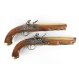 Pair of George III walnut flintlock holster pistols by Thomas Ketland & Co, the brass barrels