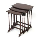Nest of three mahogany bow front occasional tables with simulated bamboo legs, the largest 63cm H