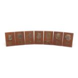 Seven bronze portrait plaques of composers on walnut strut backs including Beethoven and Wagner,