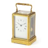 19th century brass cased carriage clock striking on a bell having an enamelled dial with Roman