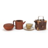 Oriental terracotta including two Chinese Yixing teapots and Japanese pot and cover, the largest