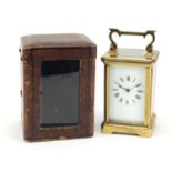 French brass cased carriage clock striking on a gong, with leather travel case, 12cm high :For